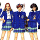 A group of Japanese high school students stand in a line, the one in the the middle wearing a sci-fi device on her arm and head.